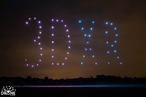 Image of a drone light show with the drones forming '3DXR'