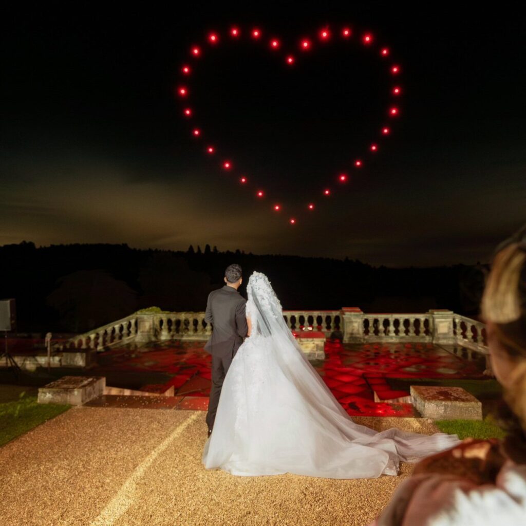 At Osmaston Park, the bride and groom gazed in awe as a mesmerizing drone show painted heart-shaped patterns in the night sky.